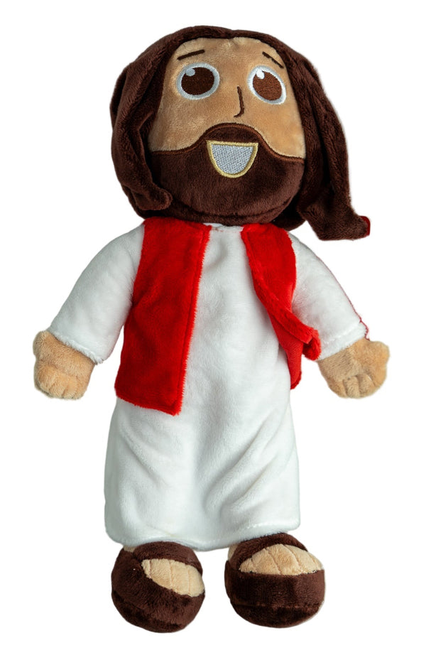 Plush toy resembling a religious figure with a white robe and red scarf on a white shelf.